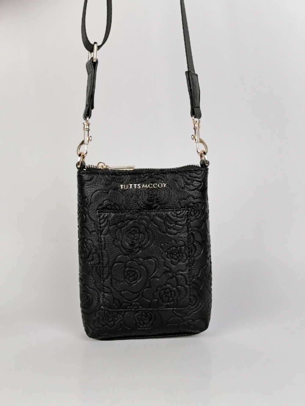 Black Floral Embossed Crossbody Bag by Tutts Mccoy